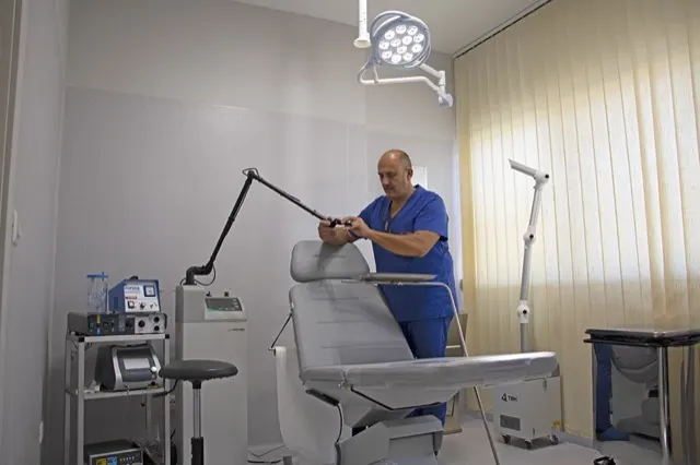 Il Dott. Russo nell'ambulatorio chirurgico, con il lettino e la lampada scialitica